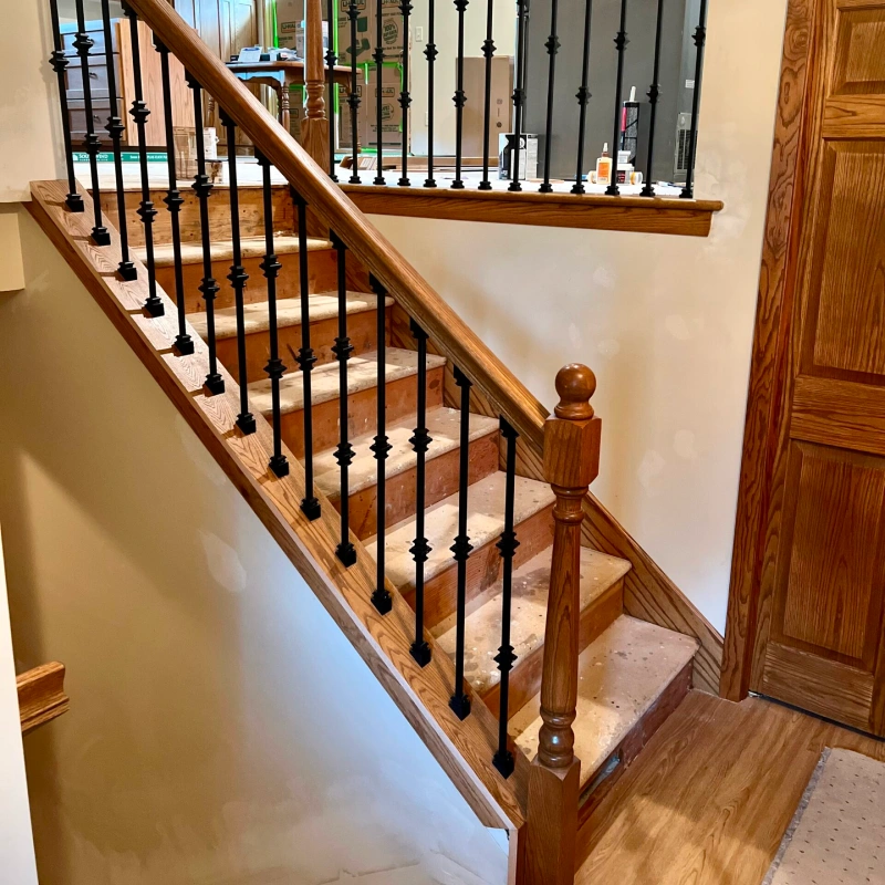 wooden staircase with black metal